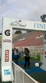 Aurora crossing the finish line (from the back) at the Rose Bowl Half Marathon 2012