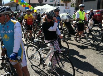 Aurora De Lucia posing with a helmet by a bicycle at the Tour de Palm Springs 2012