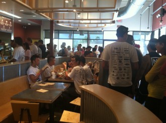 long line of cyclists at Chipotle, waiting for free burritos after the race