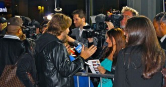 Stephen Webber being interviewed with DJ Premiere on the red carpet (from the back)