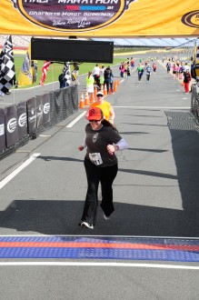 Aurora running through the finish line of the NC half marathon