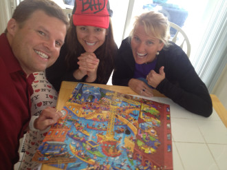 Aurora posing with her friends Wendy and Marty in front of a puzzle on a table