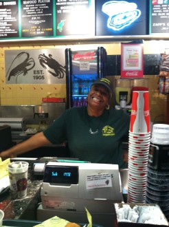 Deddie working the register at Messina's in a food court in New Orleans