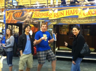 People posing excitedly outside the Brooks Running bus at the Rock 'n' Roll New Orleans expo