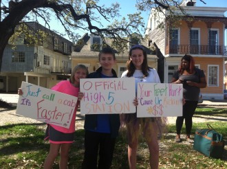 3 kids holding signs at the "official high-5 station" they made at Rock 'n' Roll New Orleans half marathon 2012