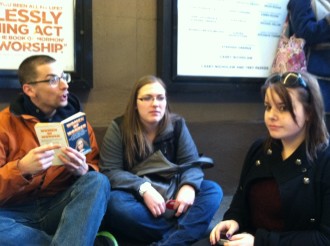 new friends playing games passing time in the Book of Mormon standing room line