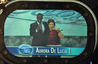 Aurora De Lucia at the American Idol Experience in Walt Disney World onstage with the host, holding her number