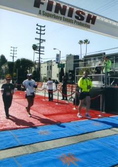 Joe and Aurora running under the finish line of the Hollywood Half Marathon 2012