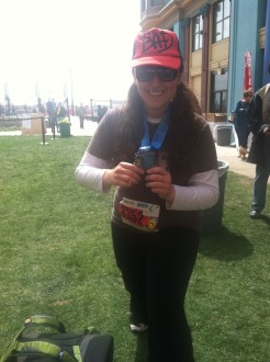 Aurora in between poses wth her medal