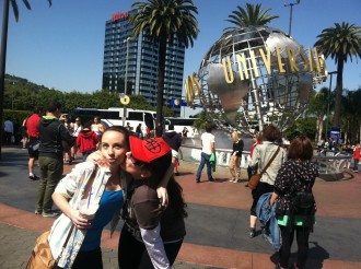 Aurora kissing her friend Amber on the cheek in front of the Universal Studios Hollywood ball