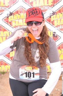 Aurora posing with her medal from the Havasu half