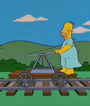 Homer Simpson on little train contraption in hospital gown, pumping arms to escape on train tracks