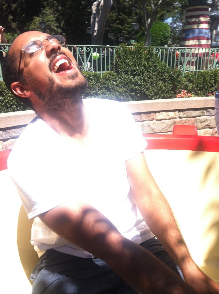 Fareed with a huge smile and head back while riding a teacup in the Mad Tea Party at Disneyland