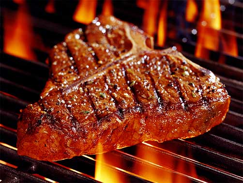 Juicy steak on a fiery grill from West Point Steak House
