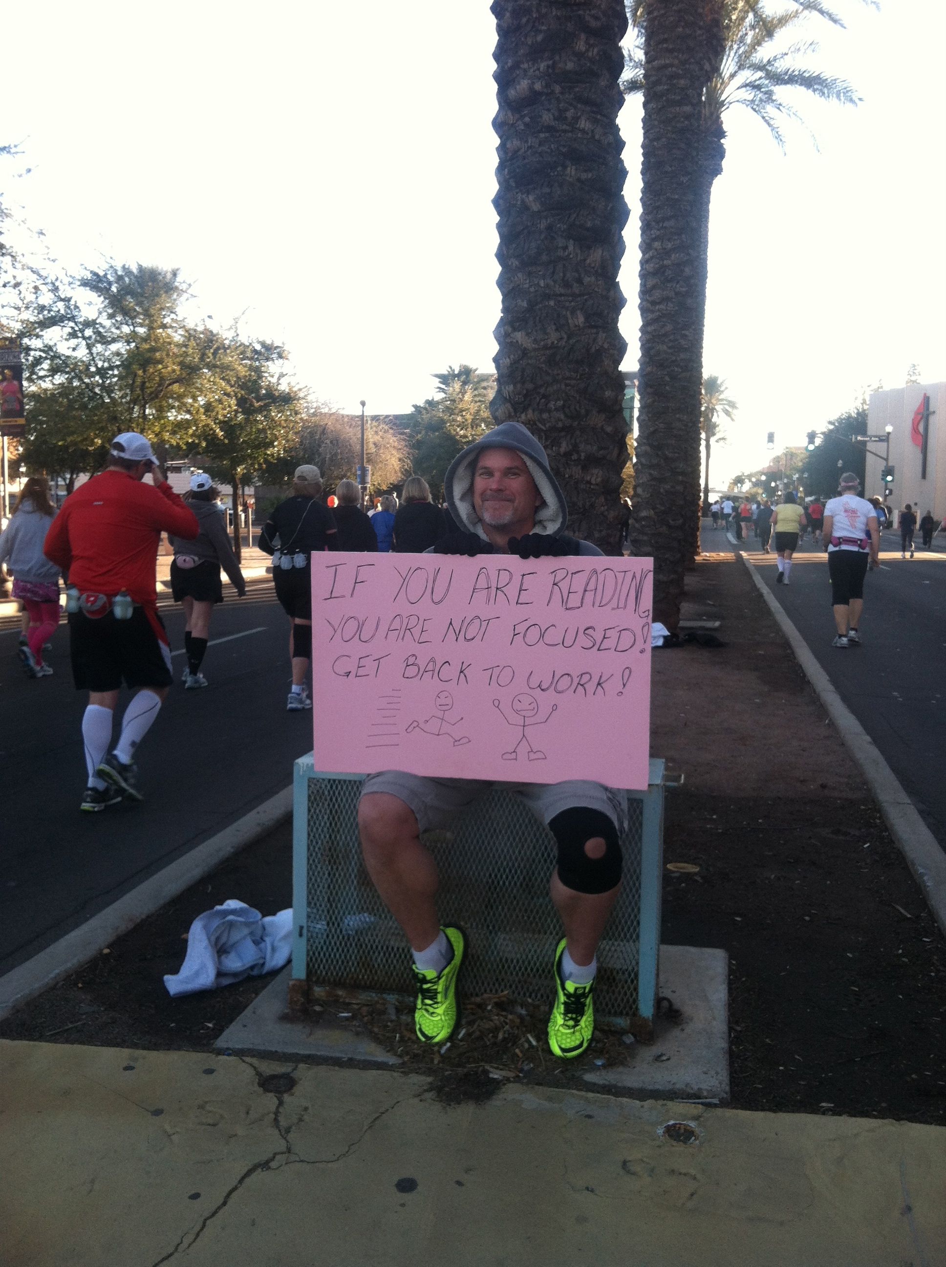 man holding focus sign for support at RnR AZ half marathon 2013