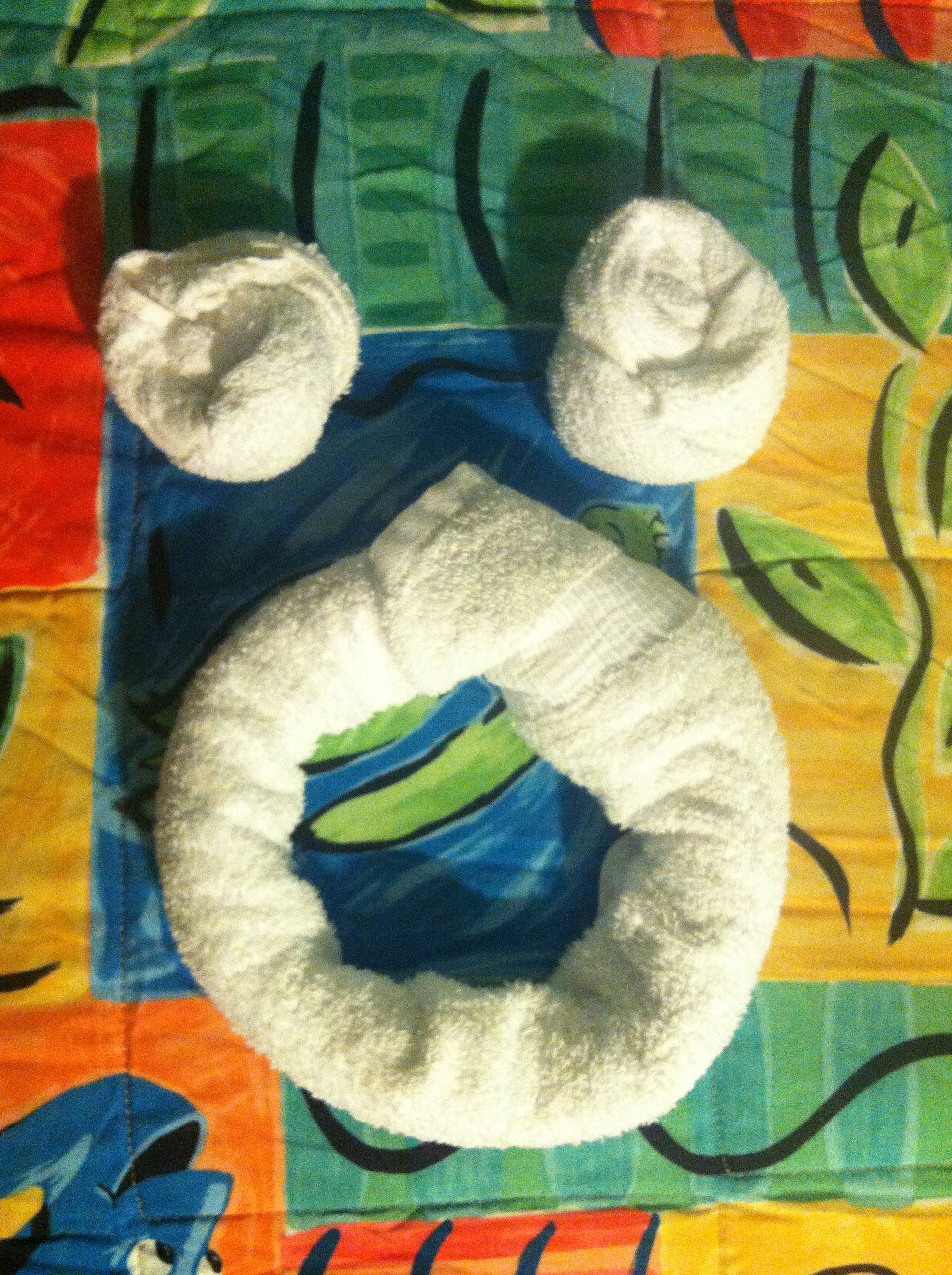 Mickey shaped towels waiting in the room.