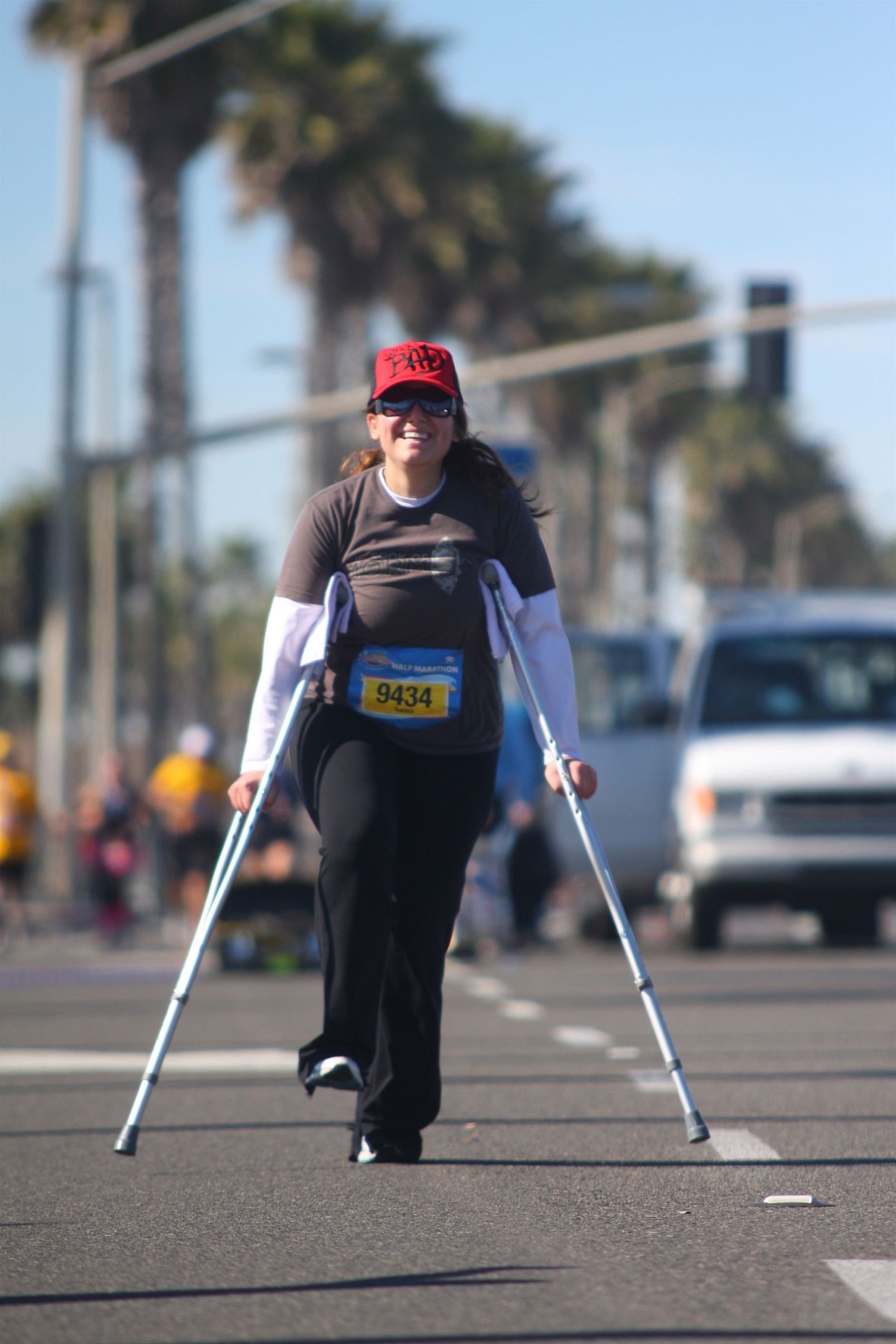 Aurora De Lucia coming into the finish of the Surf City Half Marathon on crutches