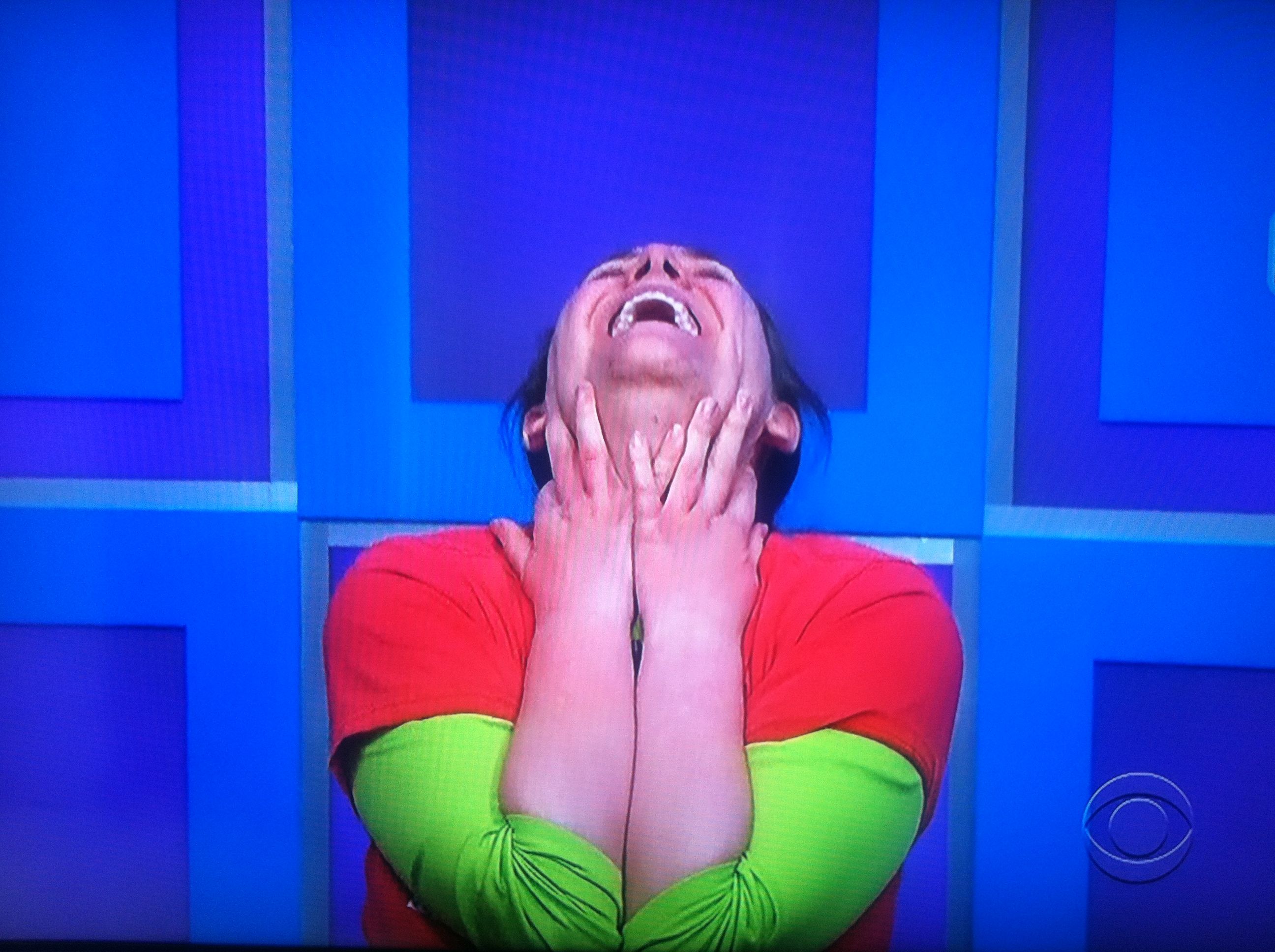 Aurora on the ground with her head back, playing for a brand new car on The Price is Right