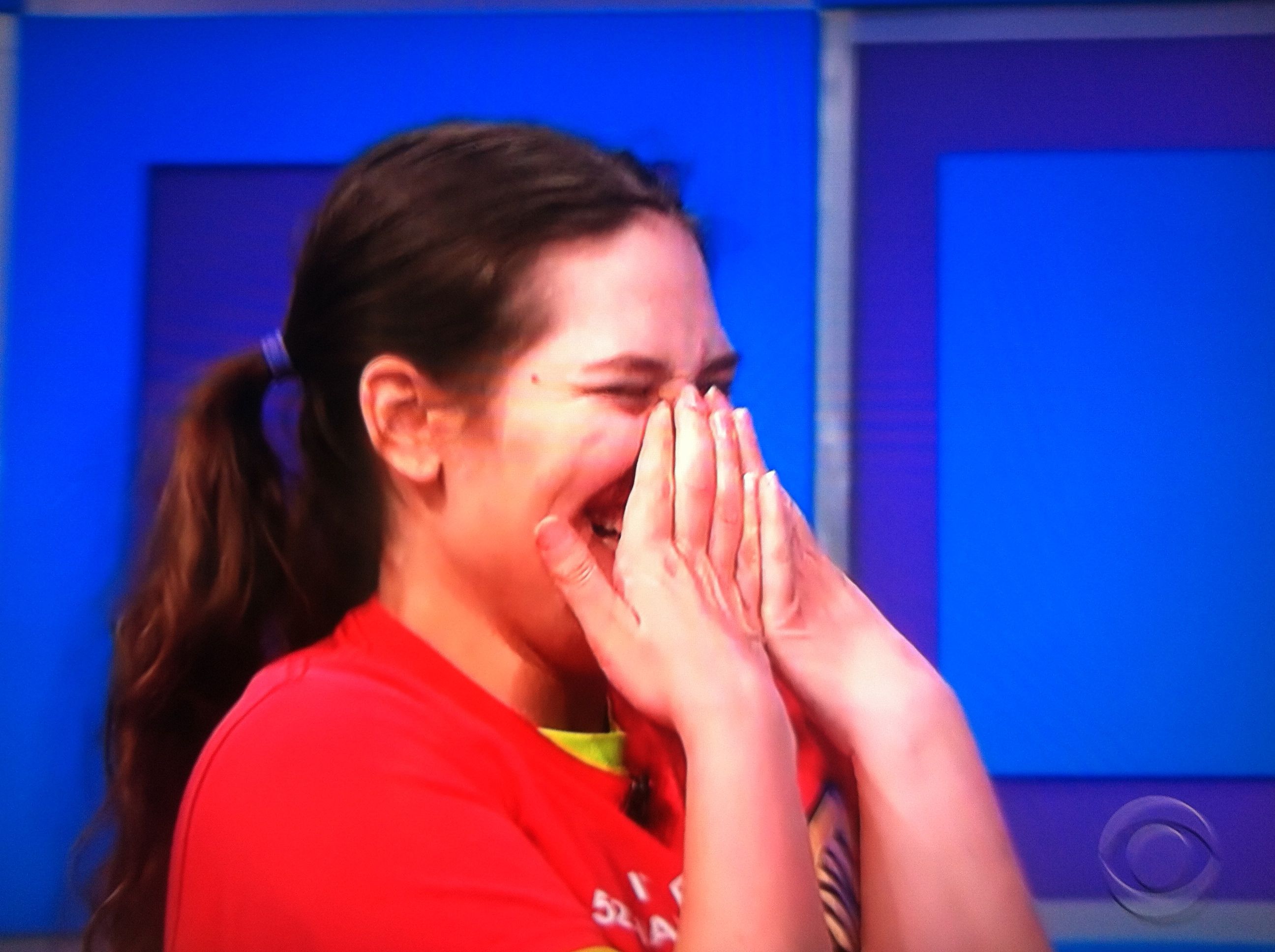 Aurora De Lucia with a huge smile/laugh as Drew Carey makes fun of her on the Price is Right