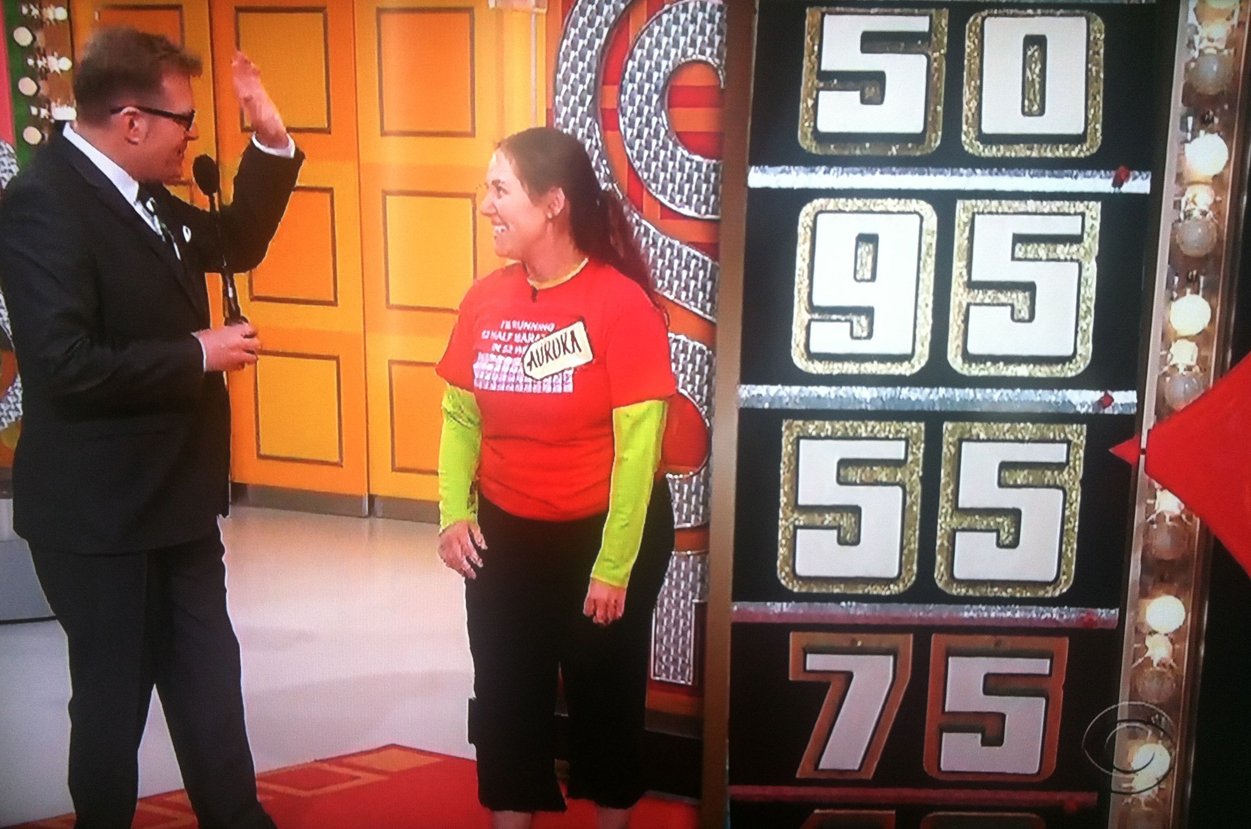 Drew Carey extending a high 5 to Aurora De Lucia on The Price is Right
