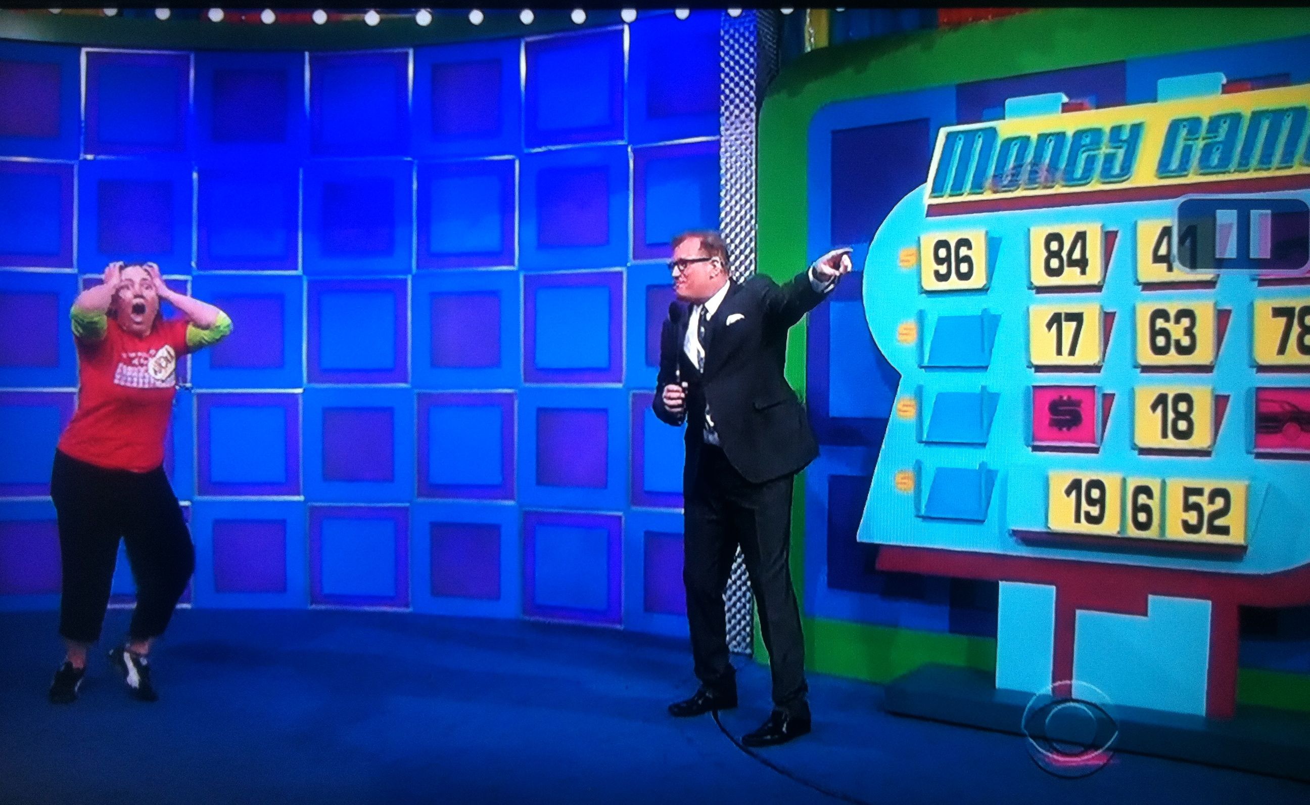 Drew Carey points and tells Aurora to go get her new car after winning on The Money Game on The Price is Right