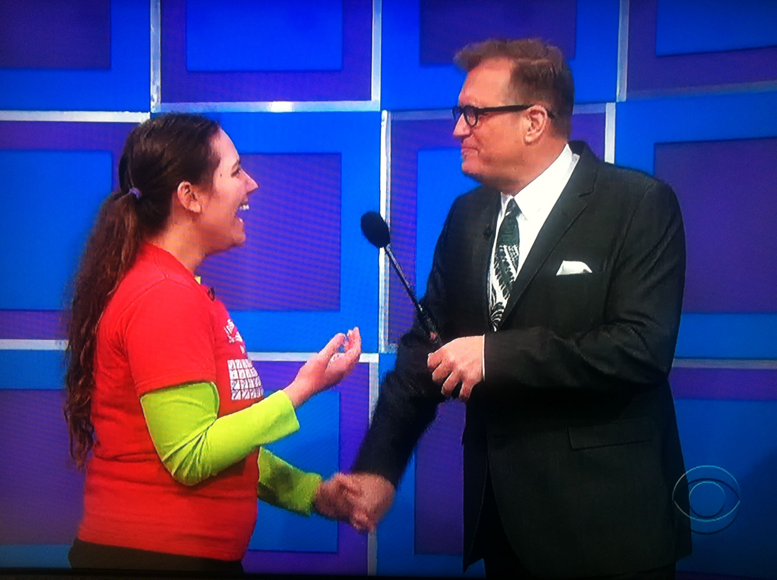 Aurora De Lucia holding hands and talking with Drew Carey on The Price is Right