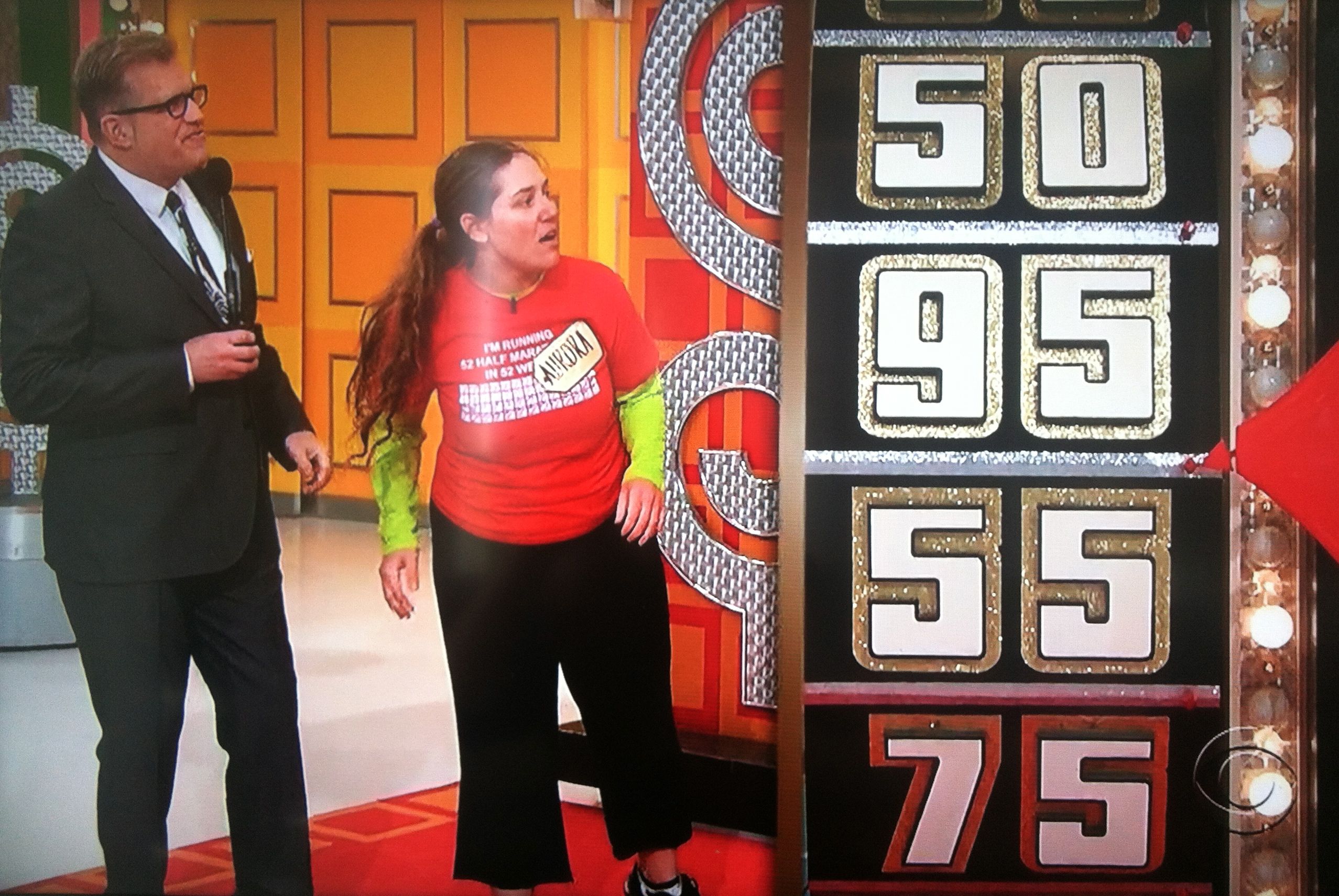 Aurora De Lucia and Drew Carey looking at The Price is Right wheel almost saying 95 cents