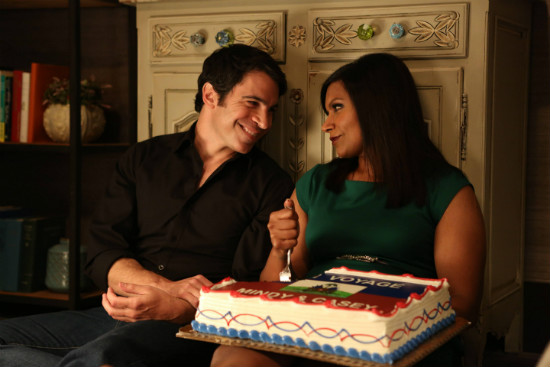 Danny and Mindy sitting on the floor eating cake