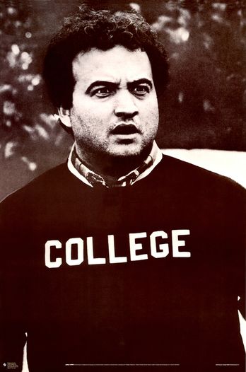 Jim Belushi wearing a college sweatshirt, making a confused face