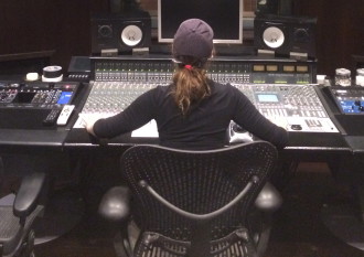 Aurora at the console in the recording studio from the back
