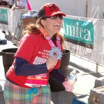 Aurora De Lucia smiling off-screen holding Women's Half Marathon 2012