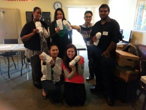 Aurora De Lucia with group posing with supplies when they passed out hygiene kits to senior citizens