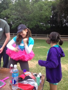 Aurora De Lucia doing the little shake the can dance at the Girls on the Run 5k Happy Hair Station