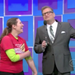 Aurora De Lucia and Drew Carey laughing onstage