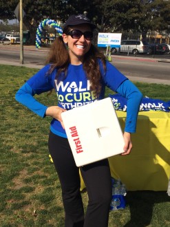 Aurora smiling while holding the first aid kit at the Walk for Arthritis
