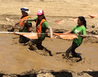 Aurora De Lucia trying to make it through the mud as a blindfolded runner at the Irvine Lake Mud Run Summer of Mud 2014
