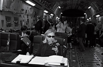 Hillary Clinton texting on a plane in black and white (same photo from textsfromhillary tumblr)