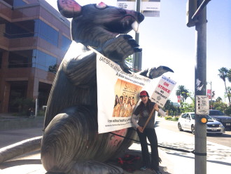 Aurora in front of a rat on an IATSE picket line