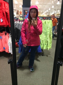 Aurora trying on a coat at Dick's Sporting Goods