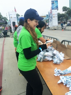 Aurora De Lucia making a silly face while sorting medals at the Long Beach 5k 2014