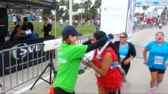 Aurora putting a medal over Gia's head at the Long Beach 5k 2014