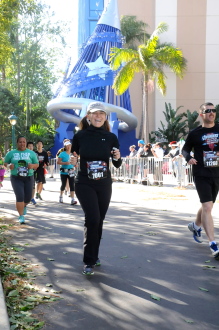 Aurora De Lucia running in front of Mickey's hat at Disneyland