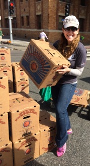 Aurora holding a box of food that's ready to be donated while collecting food with Food Forward