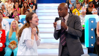 Aurora De Lucia looking with nervous big eyes as her prize is about to be revealed on Let's Make a Deal