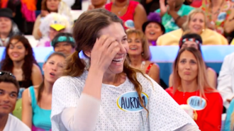 Aurora scratches her eye while looking off-camera on Let's Make a Deal