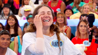 Aurora De Lucia laughing while scratching her face on Let's Make a Deal