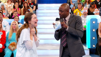 Aurora De Lucia with super big eyes looking at Wayne Brady on Let's Make a Deal