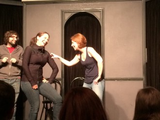 Aurora and her partner making silly faces and laughing during improv with The Deltones at iO west
