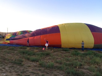 Aurora standing at the side of an inflating hot air balloon