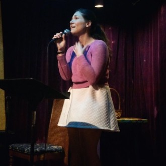 Aurora De Lucia with dreamy look at open mic poetry